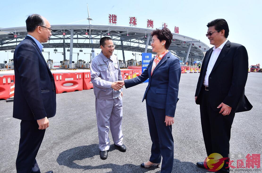 林鄭月娥（右二）在參觀後與港珠澳大橋管理局局長朱永靈（左二）握手