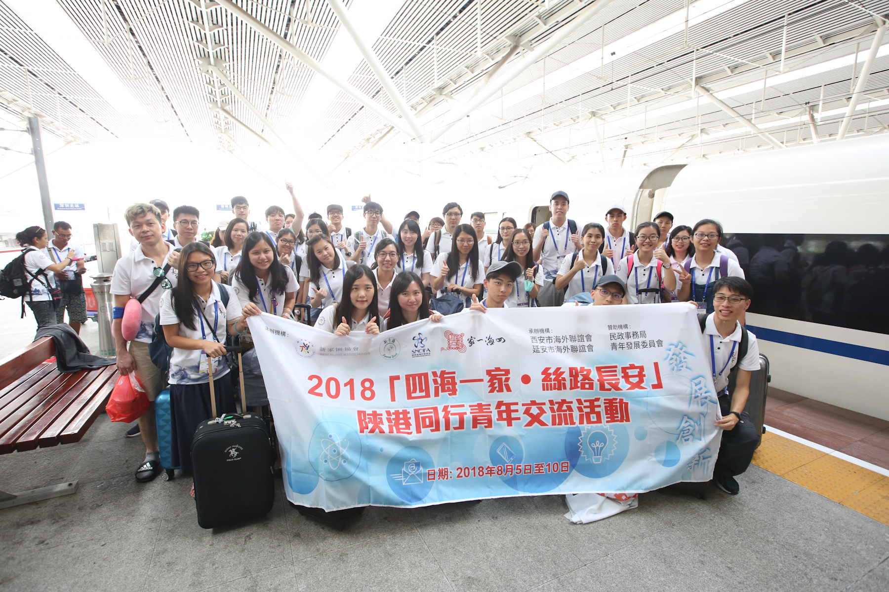 青年們在深圳北站和諧號前合影 