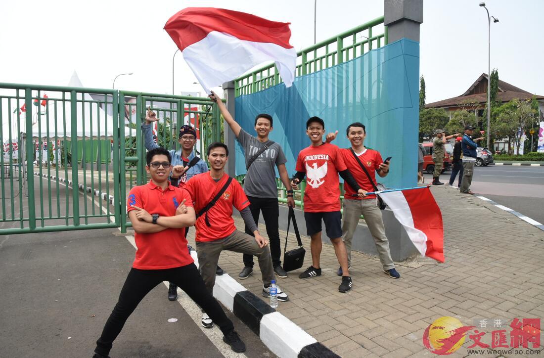 六名印尼球迷擺起帥氣姿勢並揮舞印尼國旗拍照(大文集團特派記者 張銳 攝)