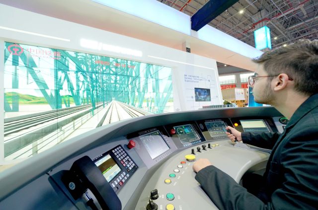 在中國國際進口博覽會的國家貿易投資綜合展(國家展)上A一名格魯吉亞政府代表團成員在中國館內體驗駕駛高鐵(11月5日攝)C新華社