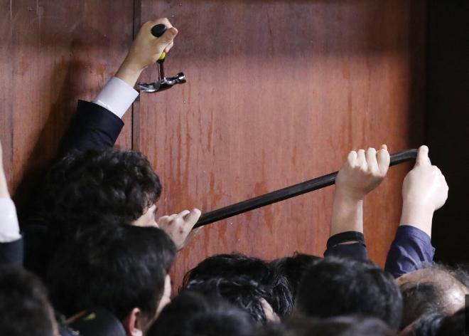 26日凌晨A韓國執政黨議員試圖用工具撬門A進入國會會場C