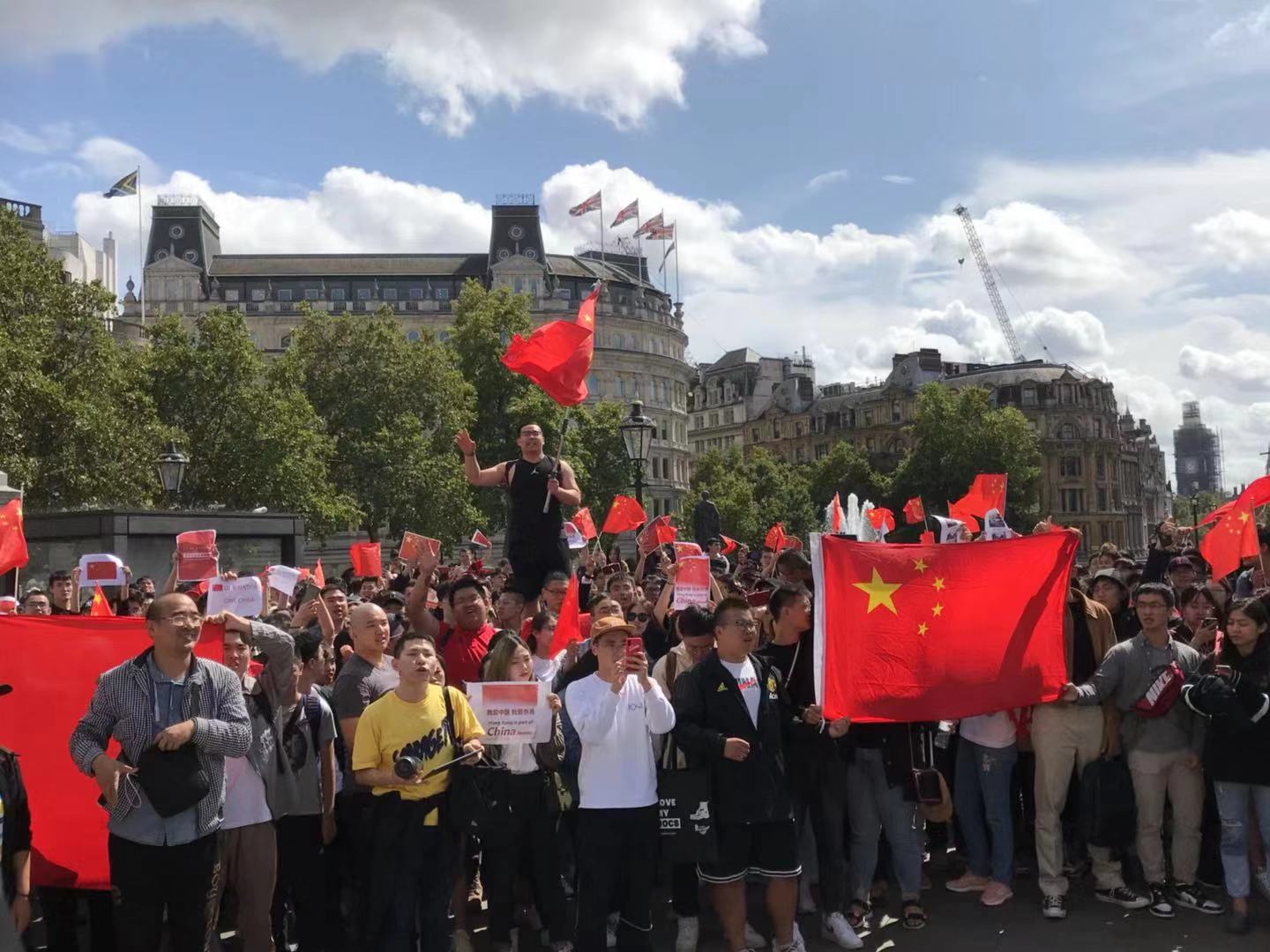 大批愛國留學生B華人華僑揮舞著五星紅旗A自發走上街頭抵制u告洋狀v 