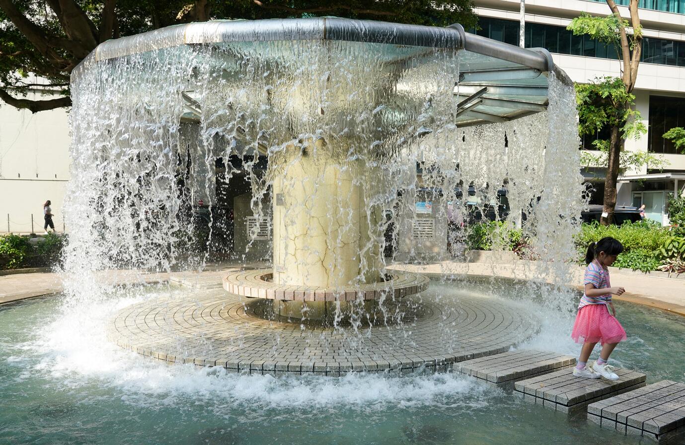 圖為2019年8月12日A香港天氣炎熱C小朋友在香港公園的噴泉涼亭戲水]資料圖片^