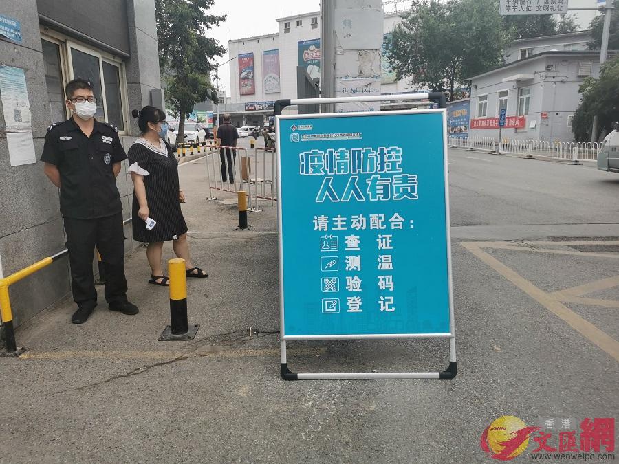 批發商在進入四道口水產市場前須先測量體溫A查驗北京健康碼並進行登記]記者 張帥 攝^